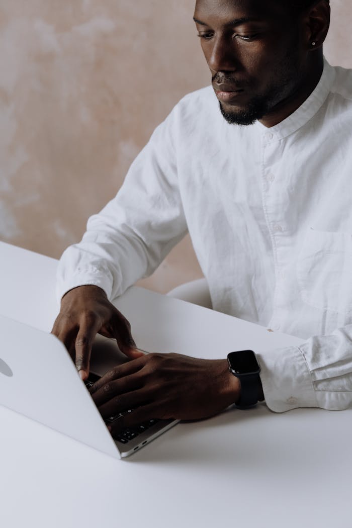 Business professional working on a laptop in an office setting, focused and attentive.